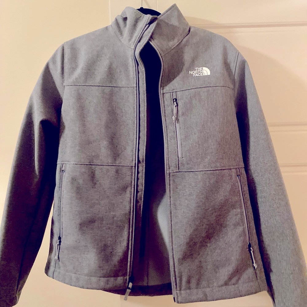 Women’s Medium North Face jacket. Worn once. Hard outer shell waterproof. Grey.